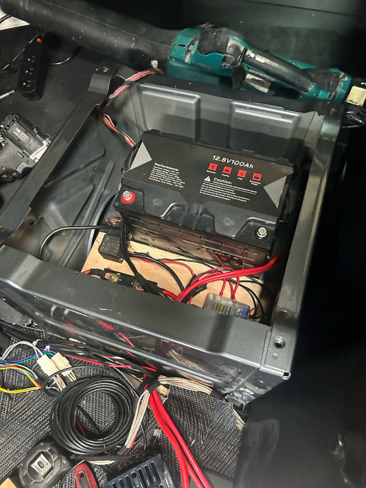 Pathfinder 12.8V 100Ah LiFePO4 battery installed in a vehicle battery box